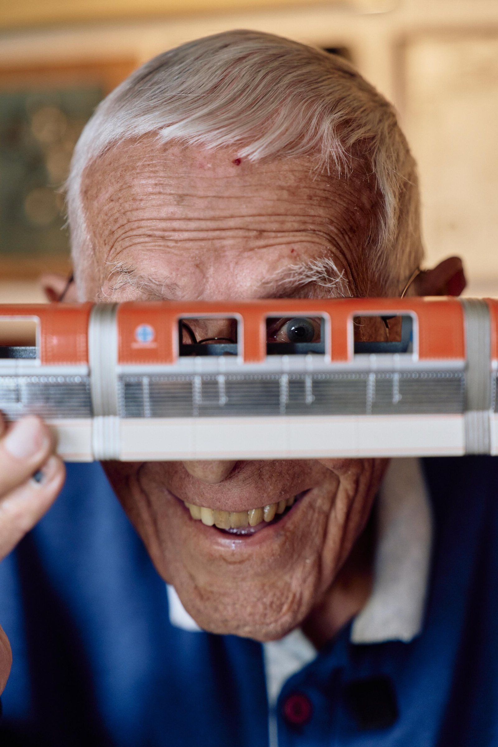 Bob Gurr looking through the window of a model monorail.