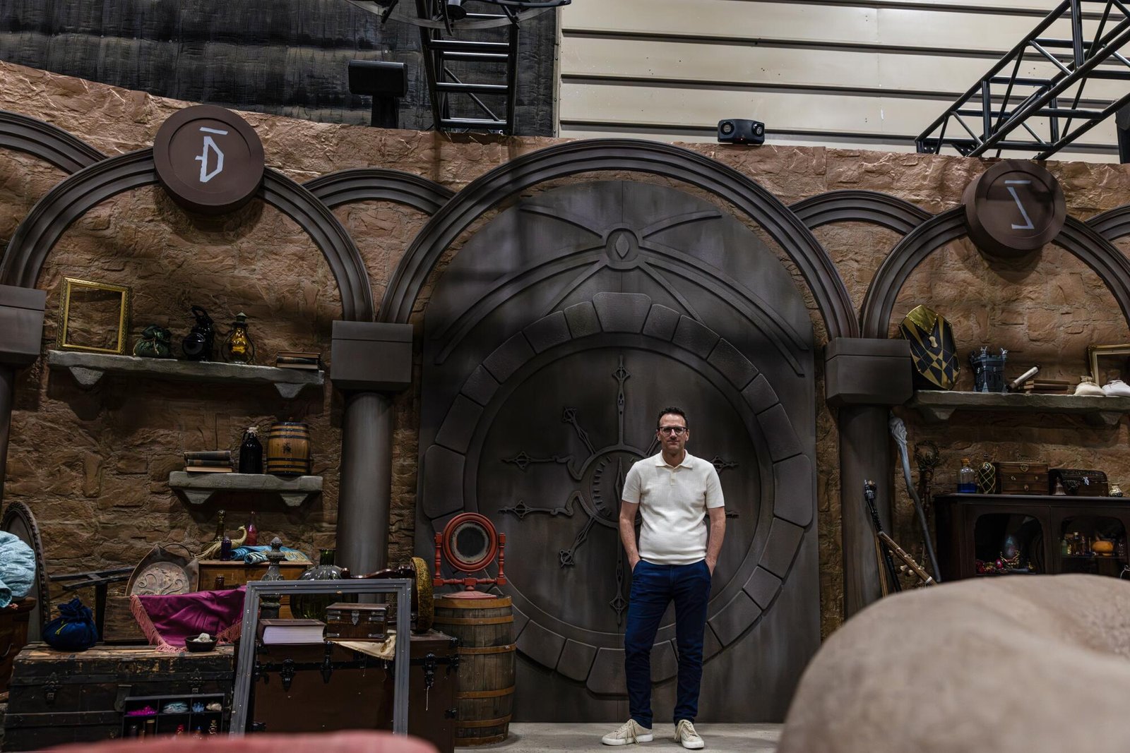 A man in a white shirt in a medieval-like fantasy setting.