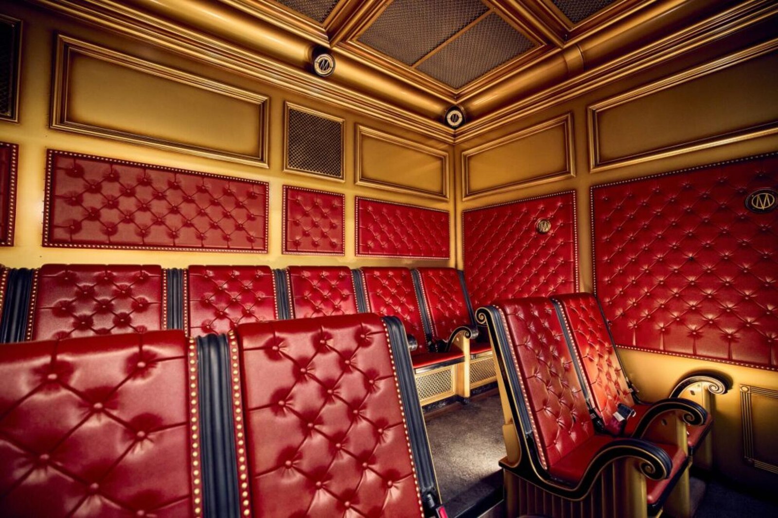 Red-adorned seats in a theme park.