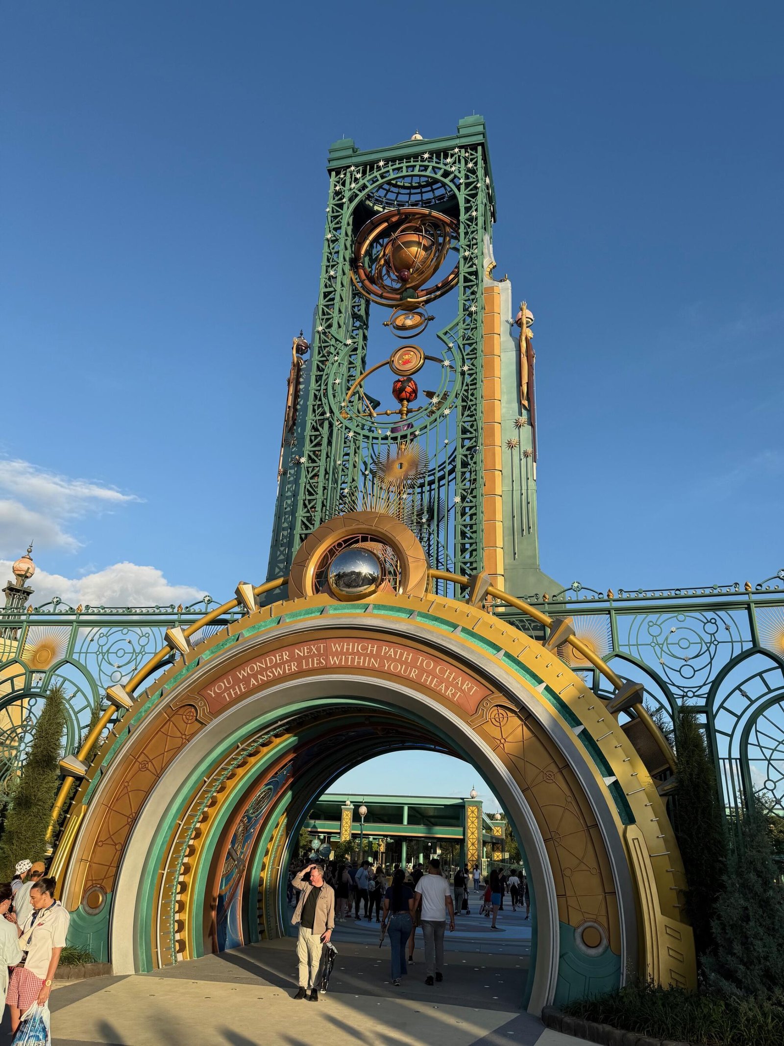A large, gold-tinged sculpture with spinning medallions.