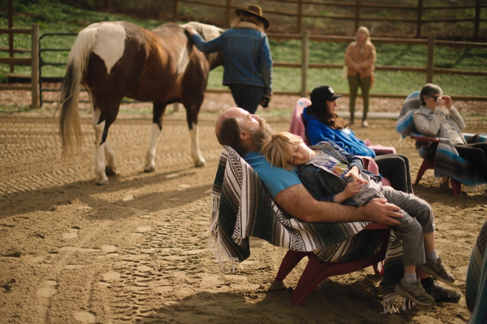 Two participants are successfully lulled to sleep as horses walk around the sound bath circle.
