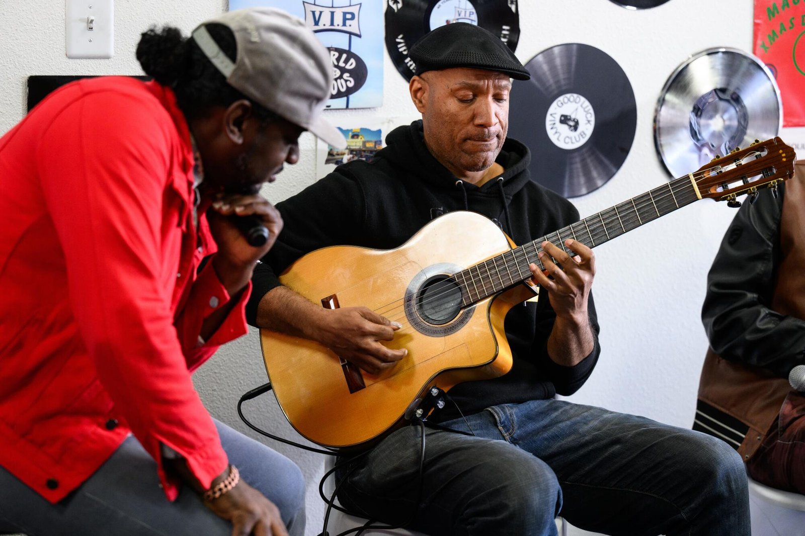 Ashanti Dykes plays the guitar at the VIP Records event.