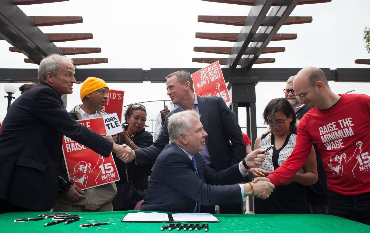 Seattle Mayor Ed Murray (C) celebrates with supporters after signing a bill that raises the city's minimum wage to $15 an hour on June 3, 2014, in Seattle, Washington.