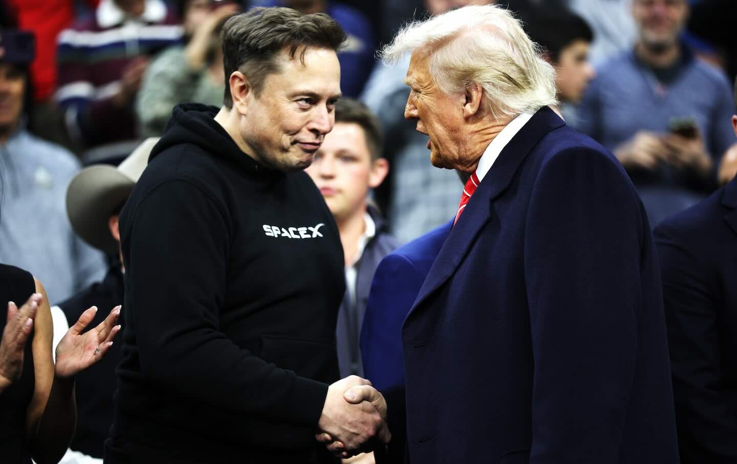 President Donald Trump and White House senior adviser andTesla and SpaceX CEO Elon Musk shake hands while attending the NCAA Division I Wrestling Championship on March 22, 2025, in Philadelphia, Pennsylvania.