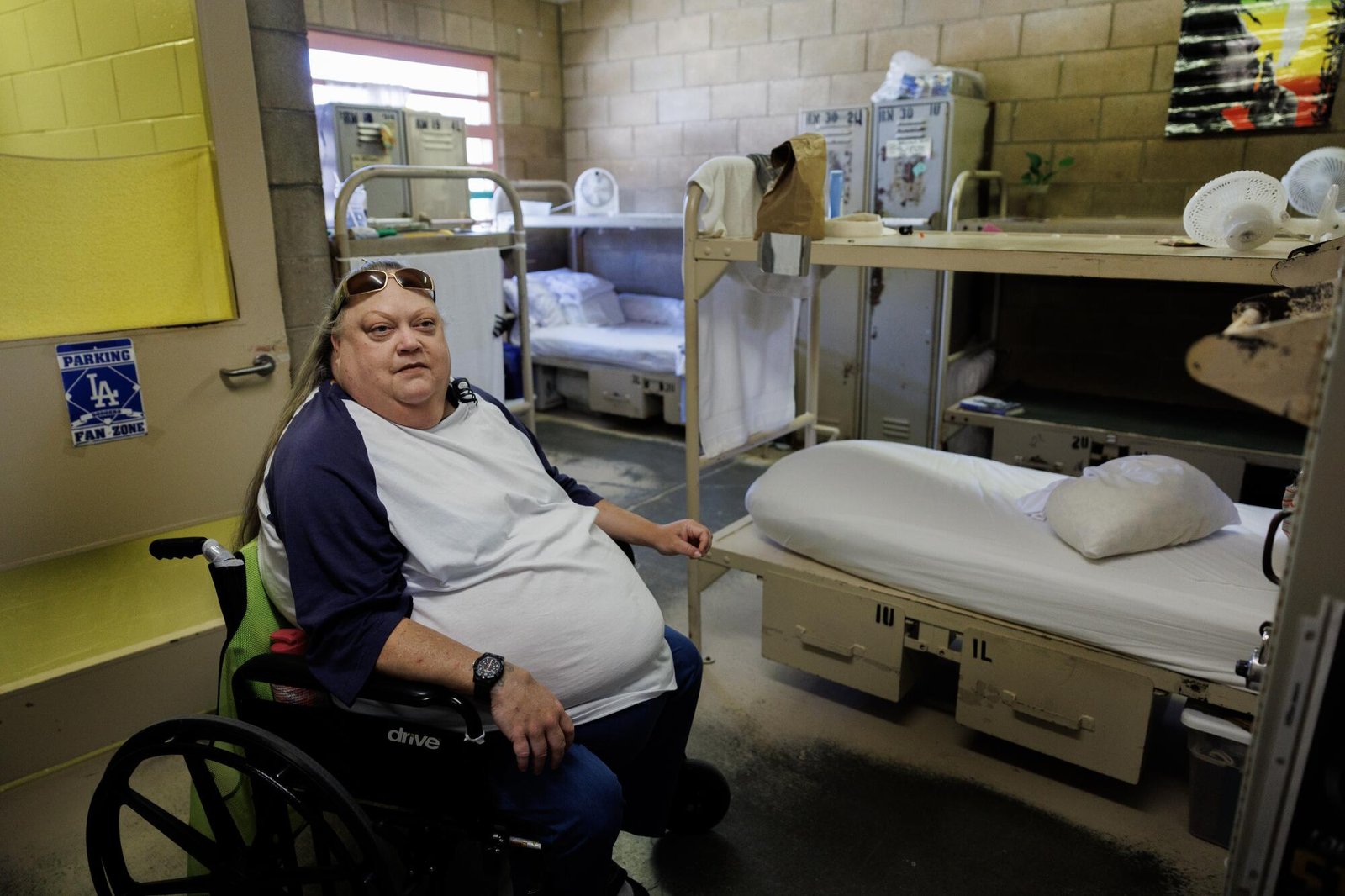 A woman sits in a wheelchair in a medical unit.  