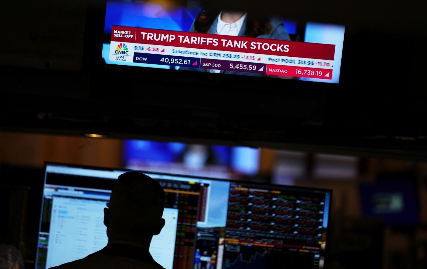 A screen displays financial news on the floor at the New York Stock Exchange in New York, Thursday, April 3, 2025.