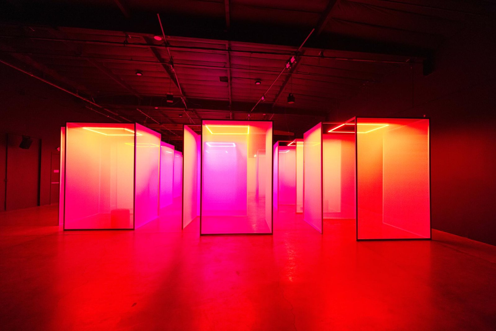 A corridor of scrims in a red hue.