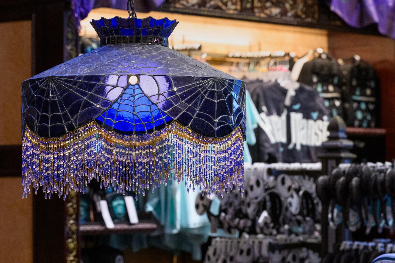 A purple-ish chandelier with web-like engravings.
