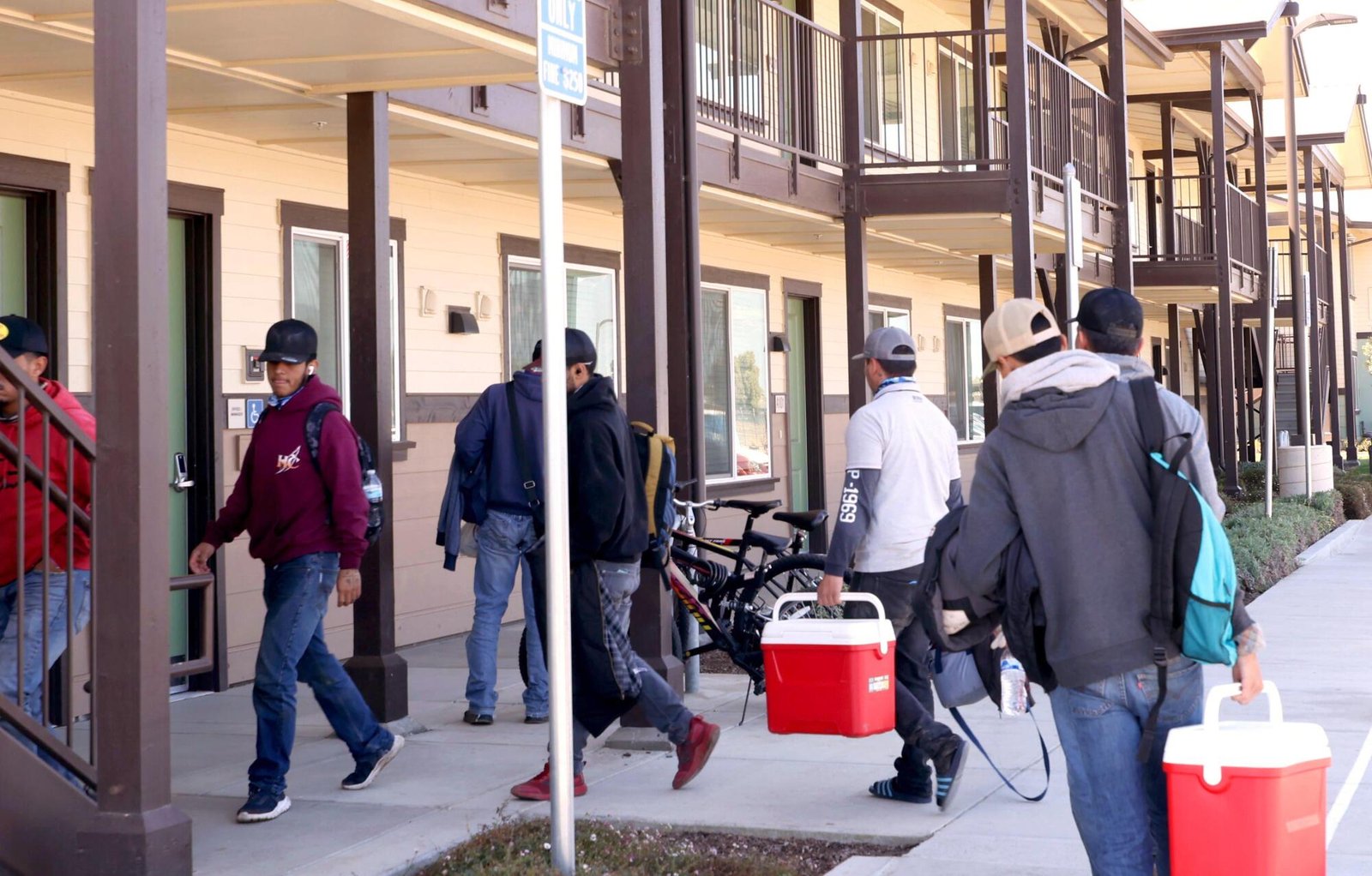 After a day of work, farmworkers return to a motel-style housing complex for H-2A guest workers.