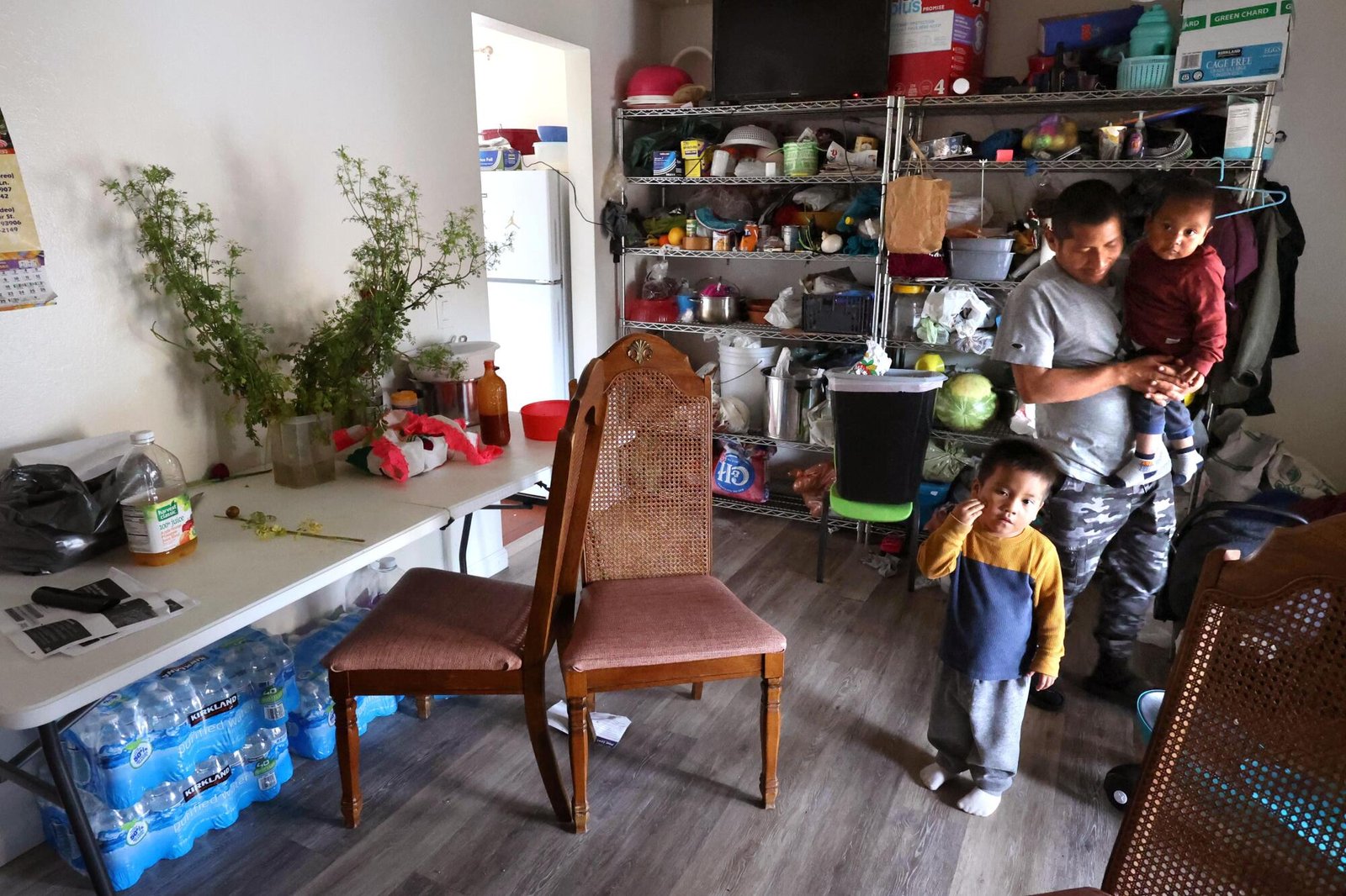 A farmworker tends to his two sons in a tidy home in Salinas.