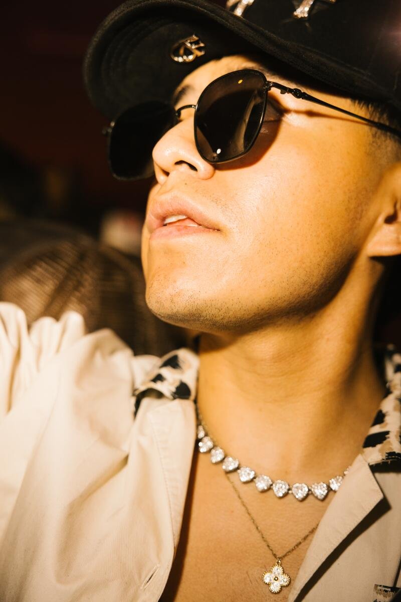 An audience member wears a diamond chain