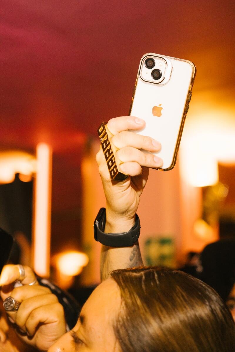 An audience member records the musicians