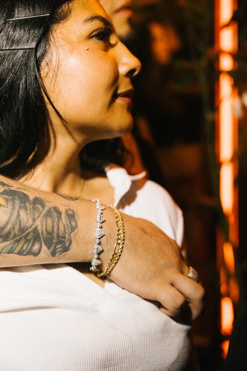 An audience member wears a diamond chain bracelet