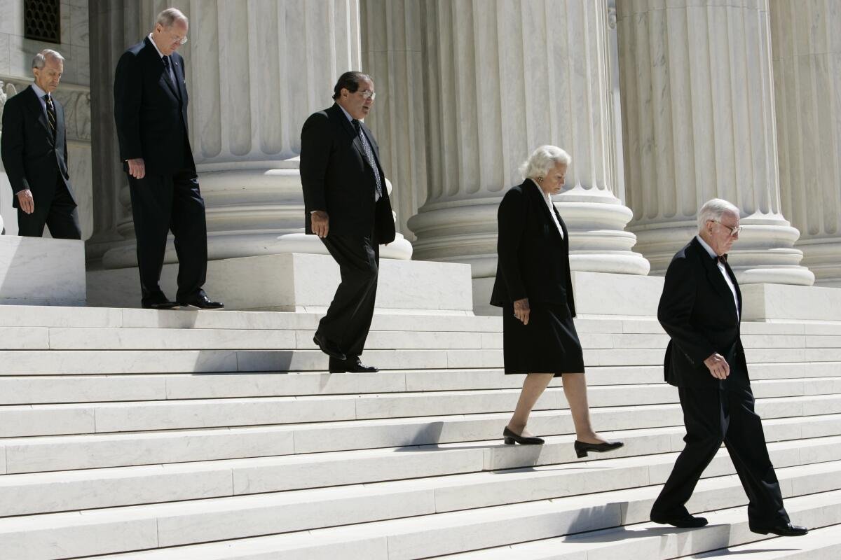 Justices of the Supreme Court walk down the steps of the Supreme Court