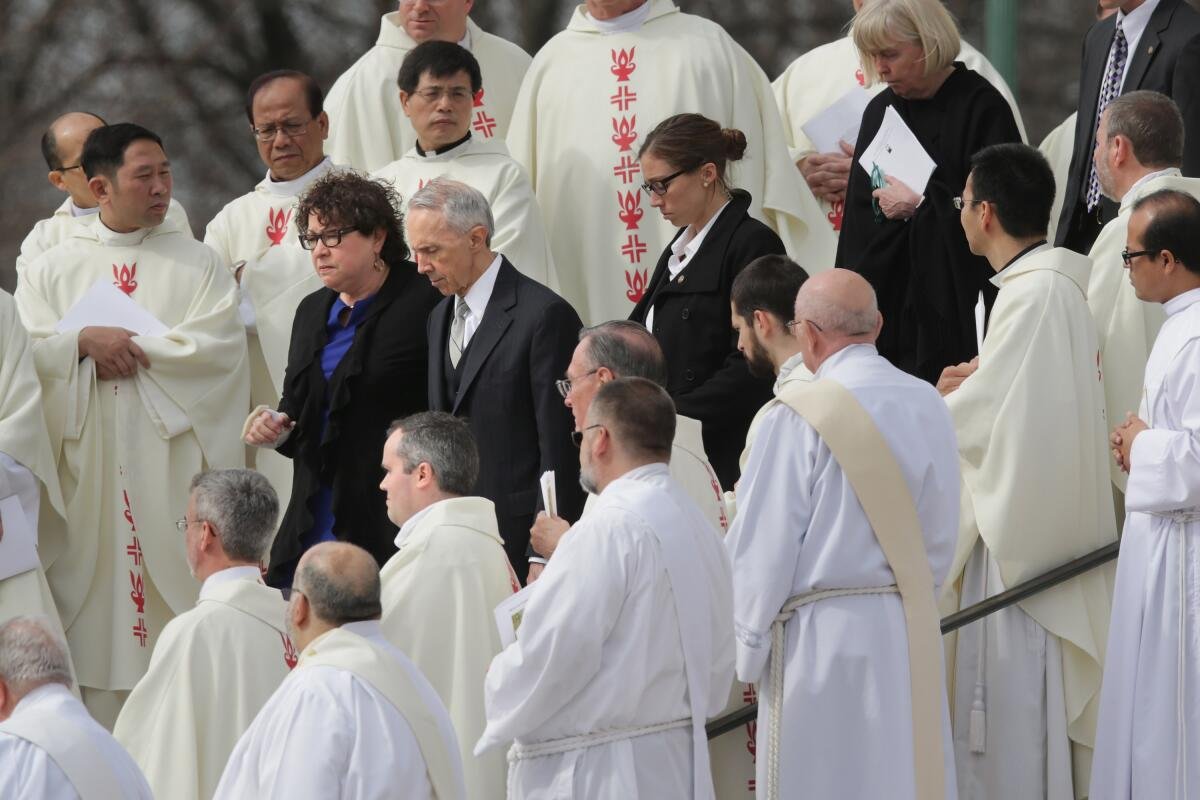  Justice Sonia Sotomayor and former Justice David Souter walk among men in vestments.