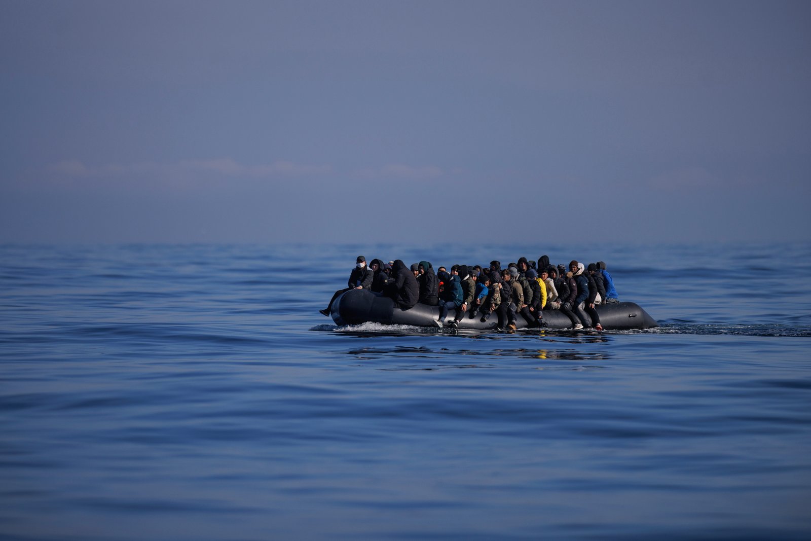 A dinghy carrying migrants crosses the Channel