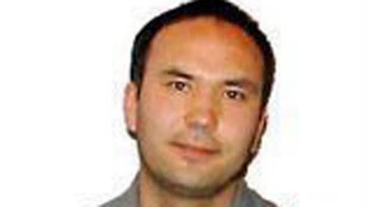 A mugshot of a man against a white background. 