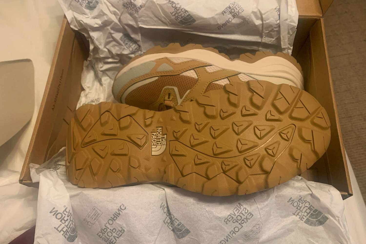 A pair of The North Face Women's Hedgehog 3 Mid Waterproof Boots in their box