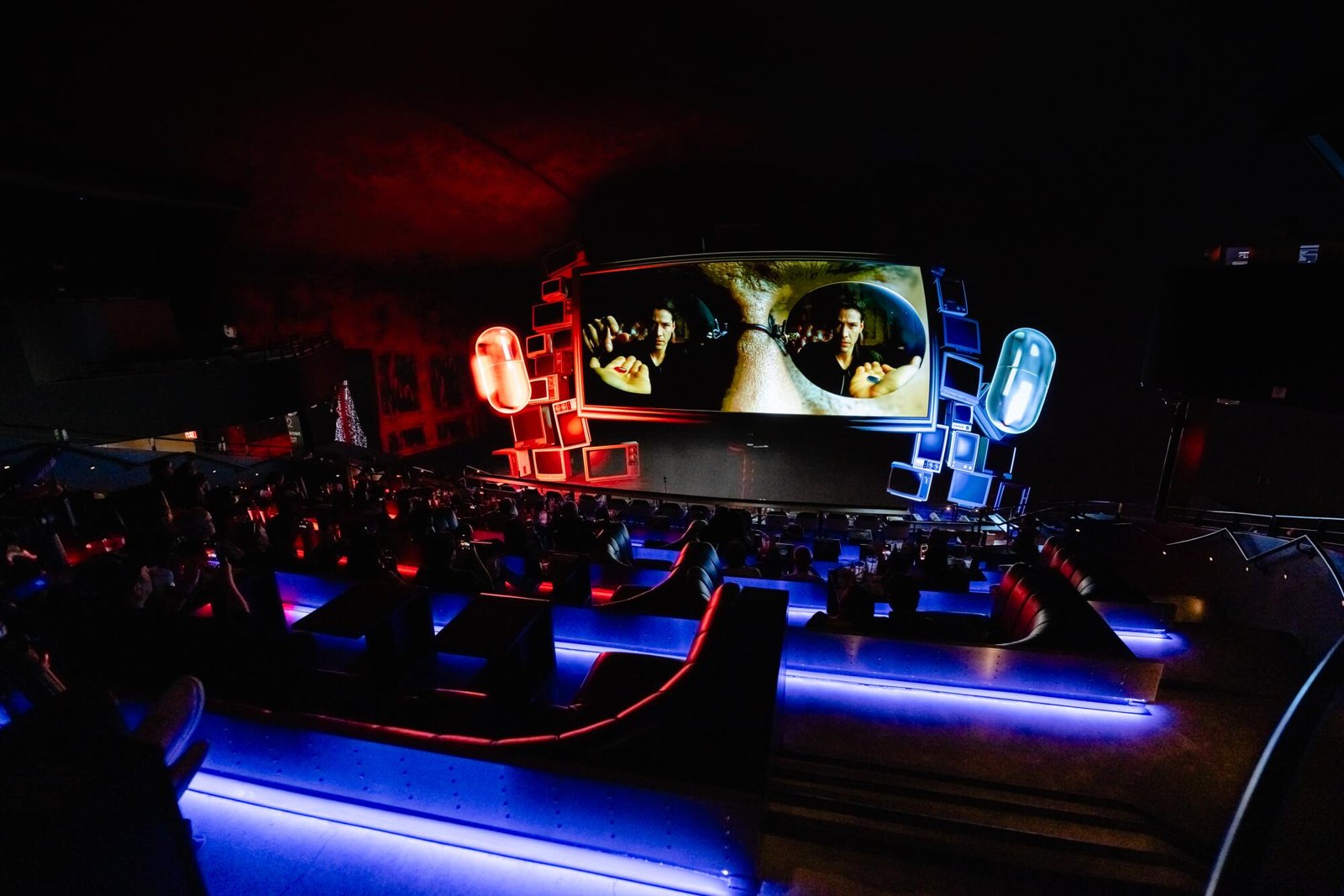 A screen of 'The Matrix' with giant red and blue pill animation surrounding it. 