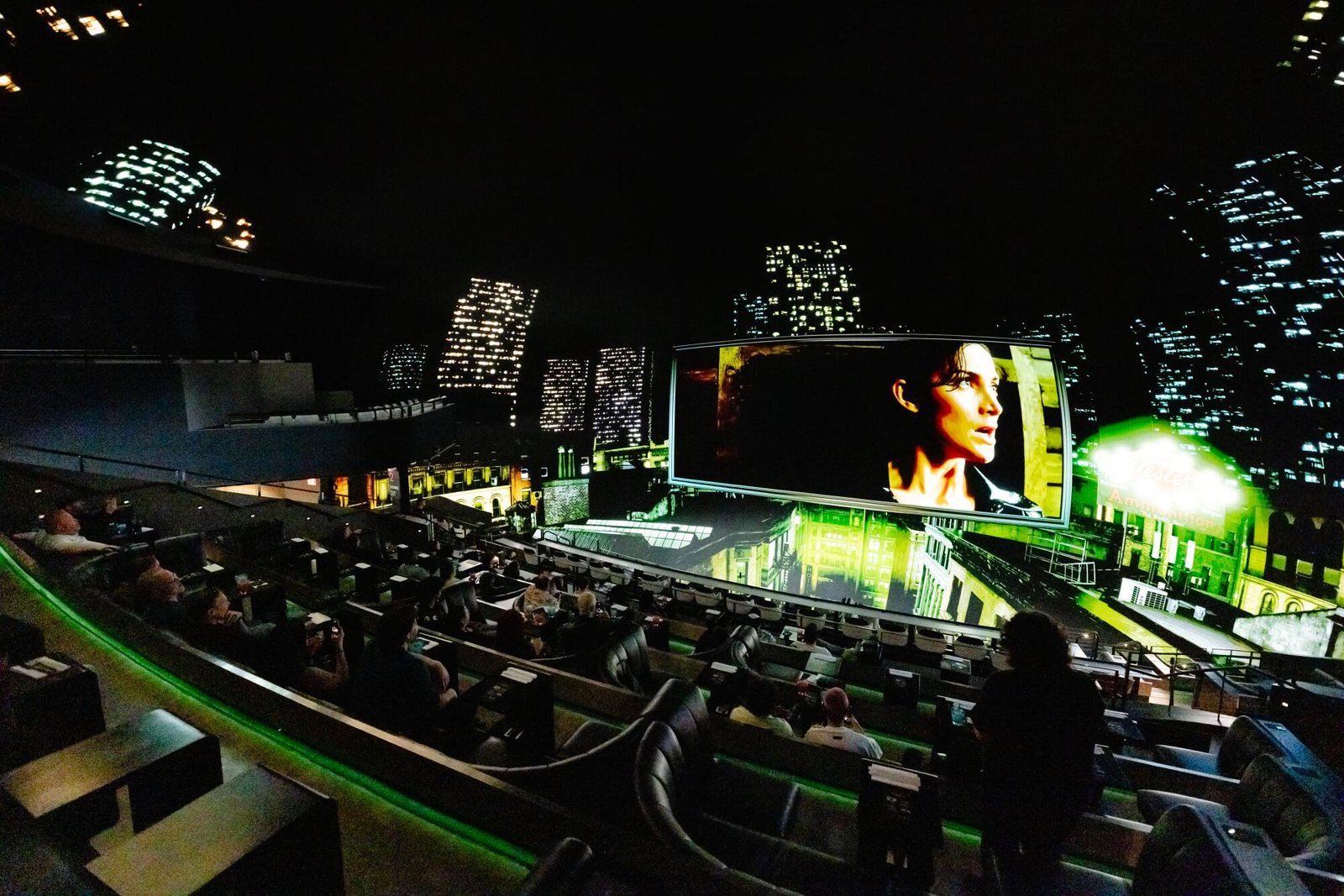 A scene of "The Matrix" starring Carrie-Anne Moss is surrounded with an all-surrounding view of a skyline.