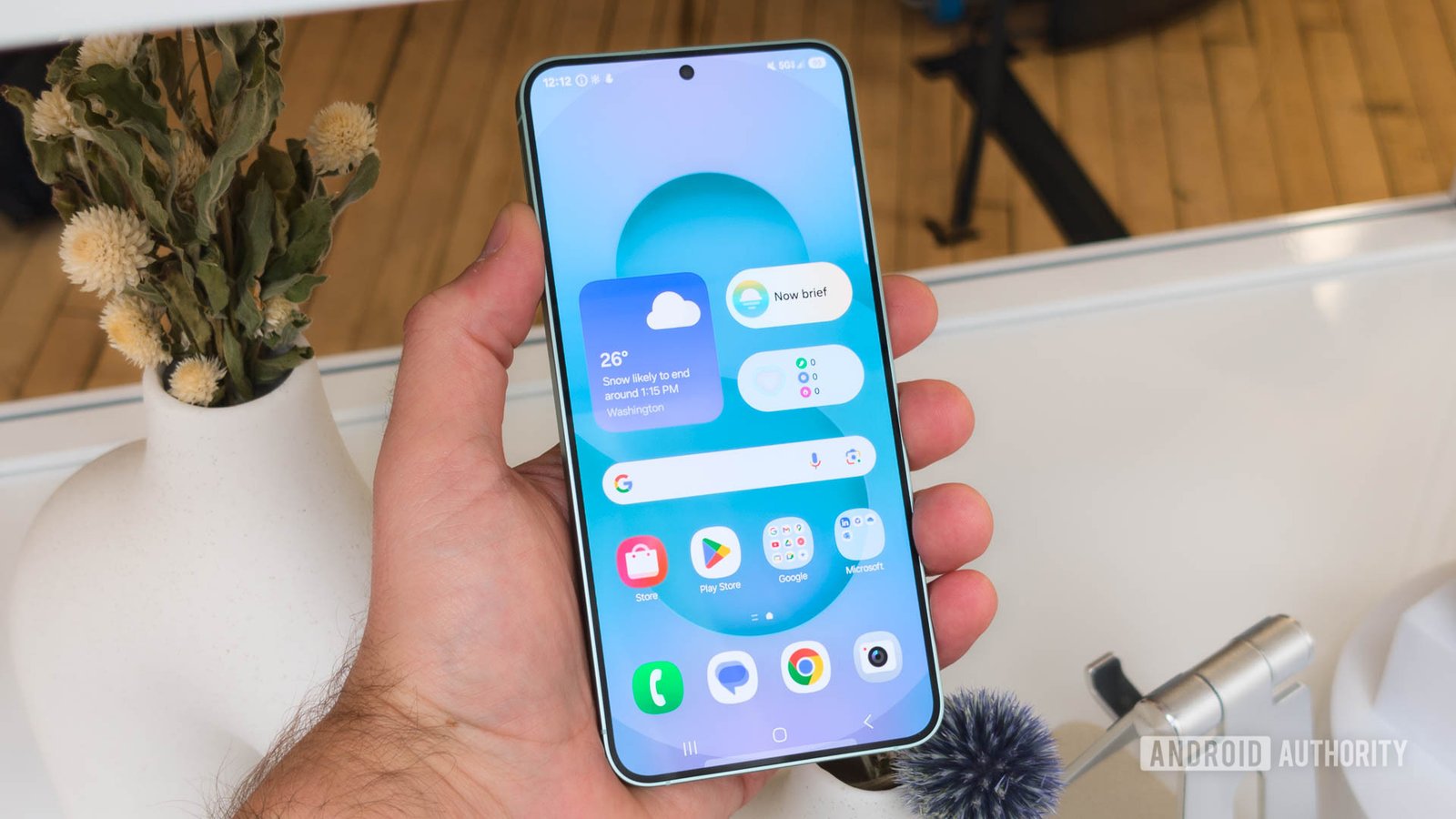 Samsung Galaxy S25 in hand showing home screen Samsung Galaxy S25 in hand showing home screen