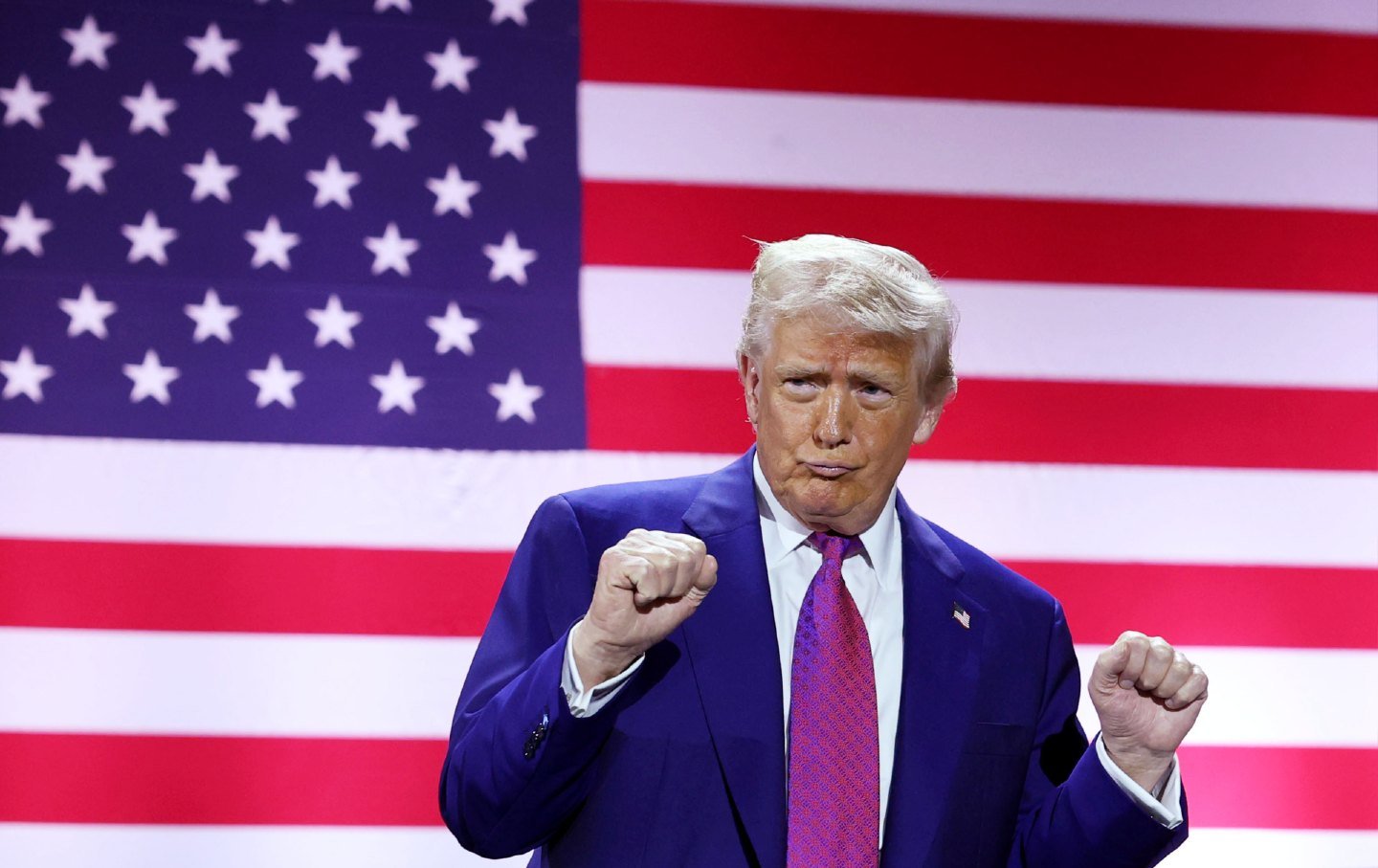 President Donald Trump gestures on stage as he tours the Al Udeid Air Base on May 15, 2025, in Doha, Qatar.