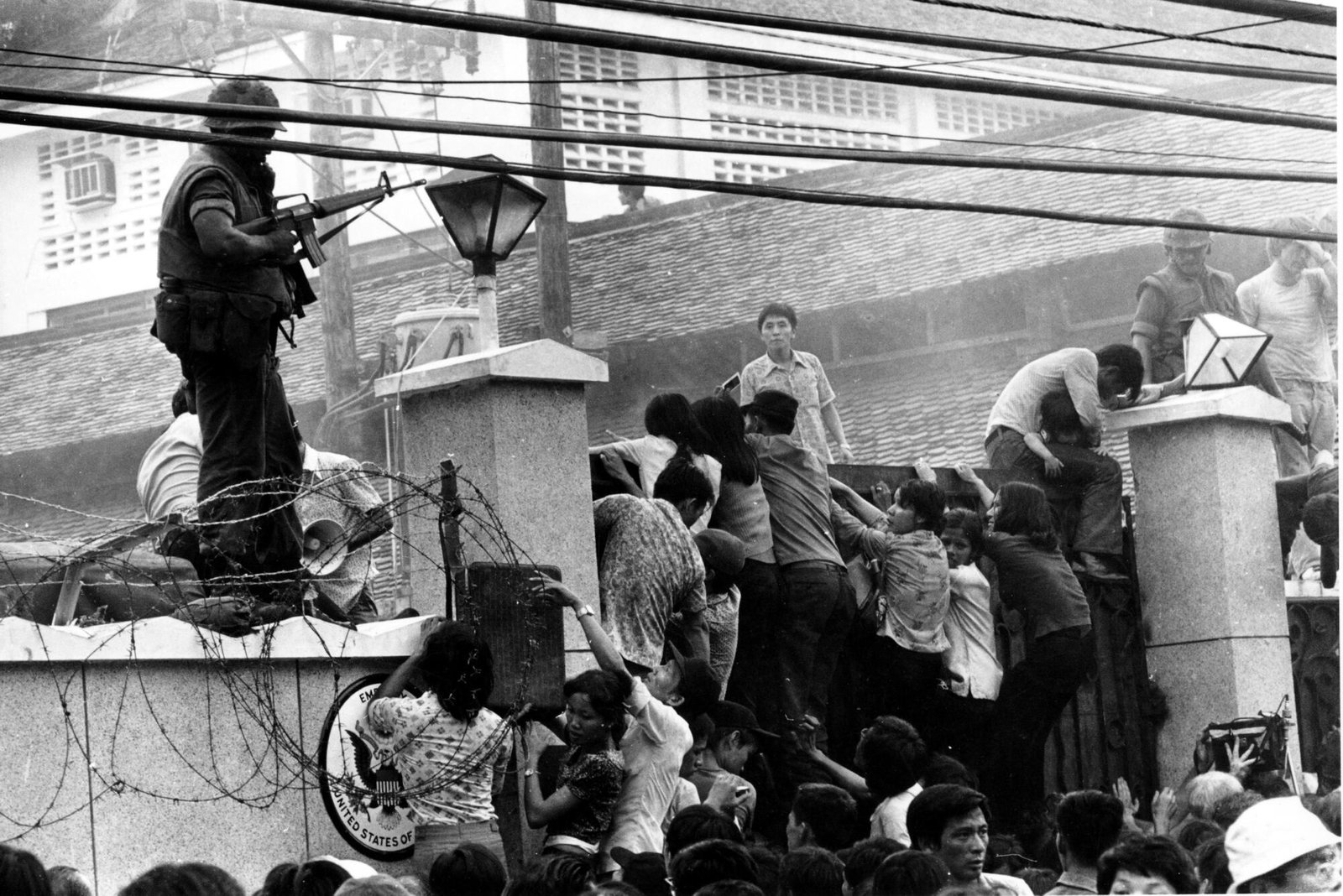 Mobs of Vietnamese scale the wall of the U.S. Embassy in Saigon on april 29, 1975
