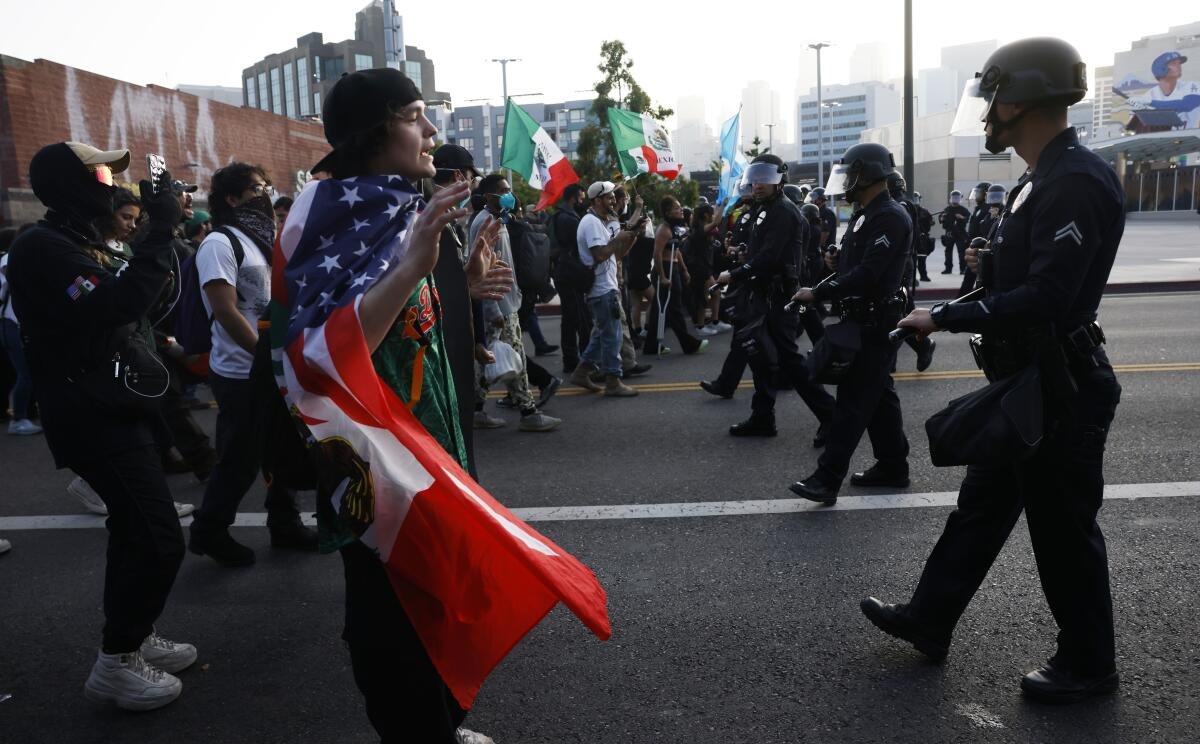 Los Angeles police officers push back protesters near a federal building in downtown Los Angeles on Monday.