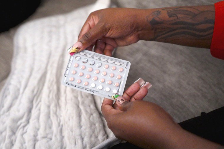 D'Asia Jackson holds her birth control pills during an interview with NBC News sickle cell disease