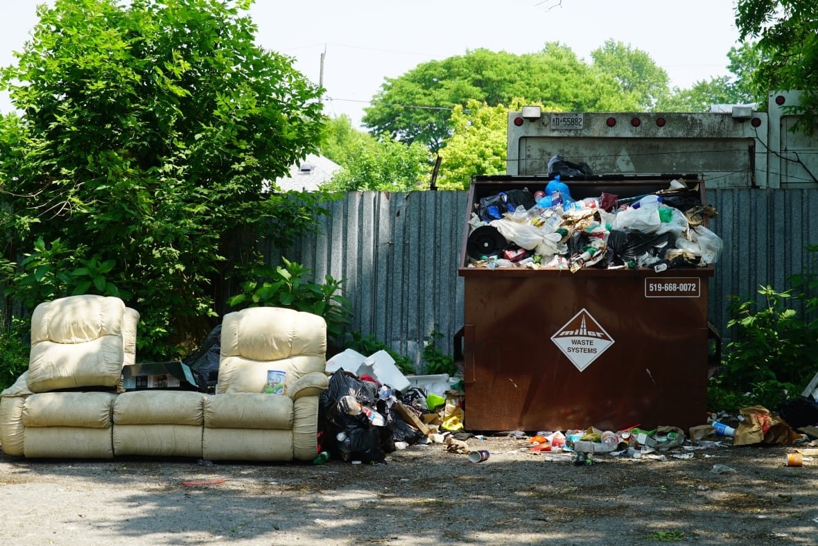 Garbage can be seen overflowing at 308 Egerton Street in London, where tenants say their trash hasn't been collected since April. 