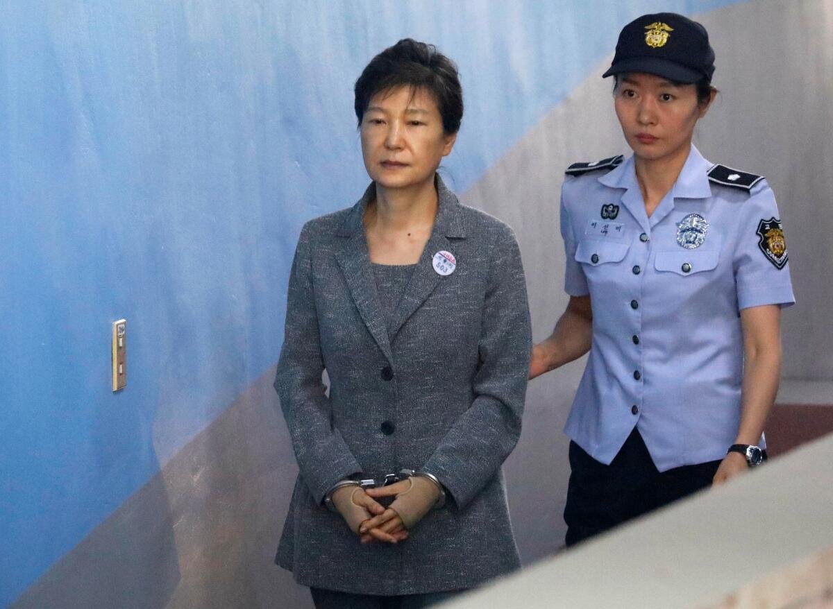 Former South Korean President Park Geun-hye, wearing handcuffs, arrives at the Seoul Central District Court in 2017.