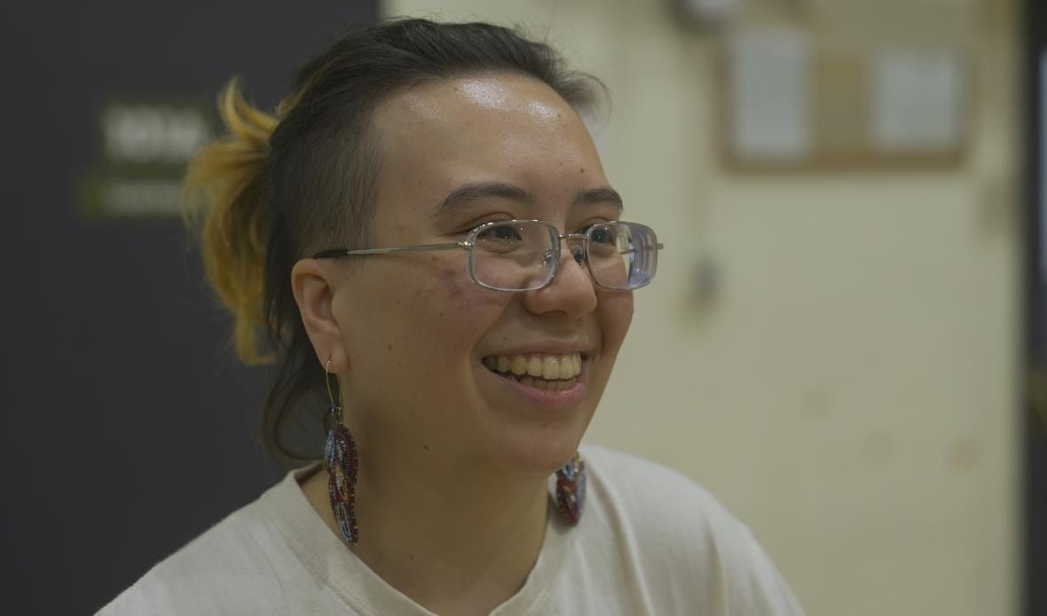 An individual smiles for the camera.