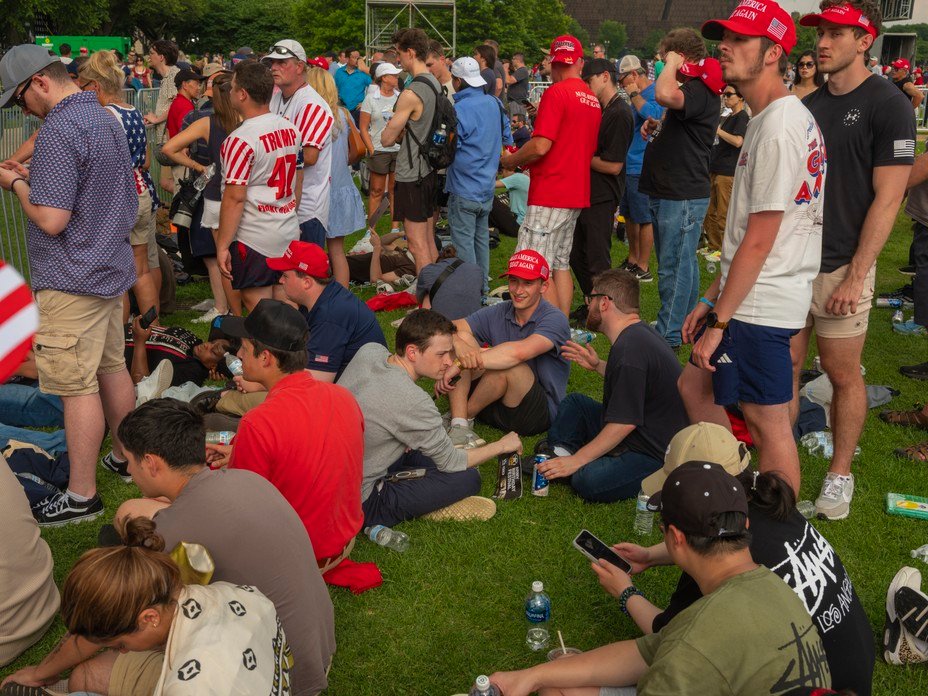 Picture of onlookers waiting for a glimpse of President Trump, who watched the parade from a stage south of the White House.
