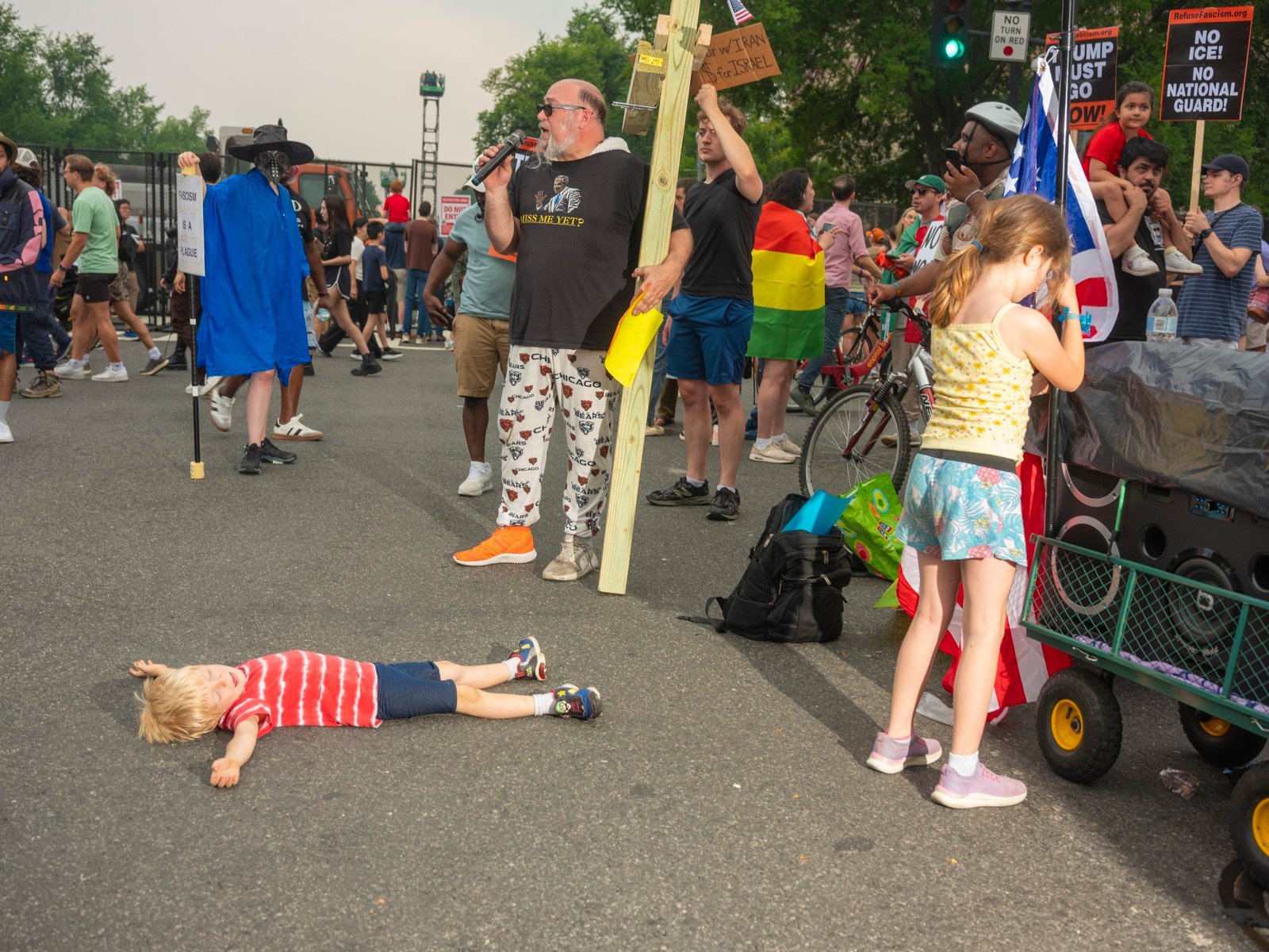 Picture of a child taking a moment of respite as protesters demonstrate near the parade route. 