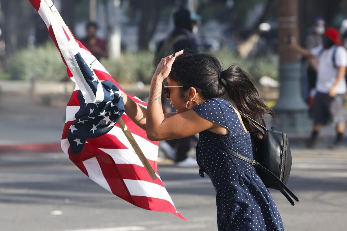 A protester is fired upon with non-lethal weapons by the L.A. Sheriff's eputies on Saturday in downtown Los Angeles.