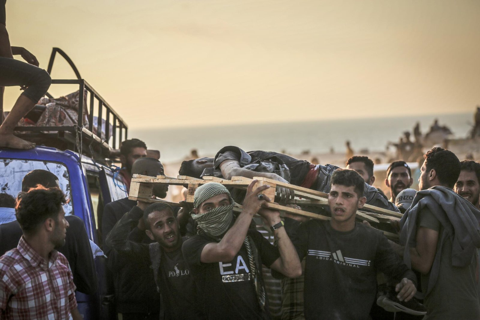 People carrying a wounded man