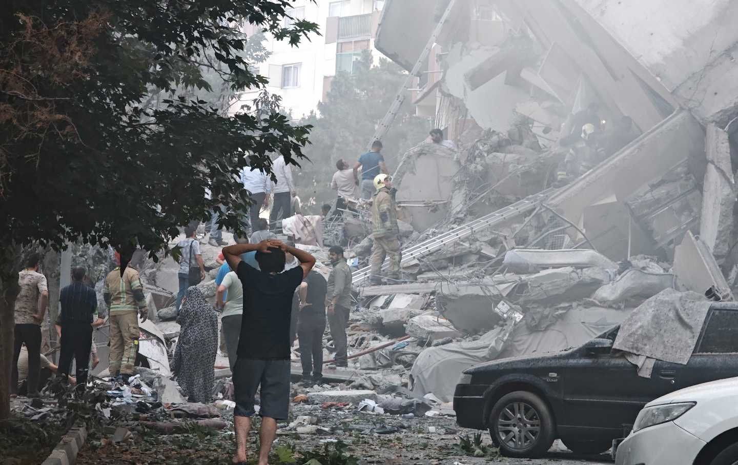 People look over damage to buildings in Nobonyad Square following Israeli air strikes on June 13, 2025, in Tehran, Iran.