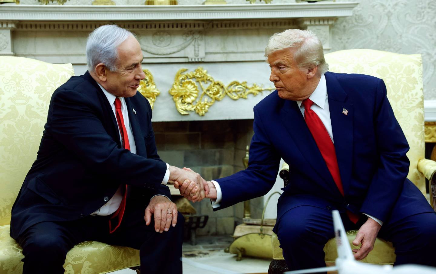 US President Donald Trump (R) shakes hands with Israeli Prime Minister Benjamin Netanyahu during a meeting in the Oval Office of the White House on April 7, 2025, in Washington, DC.