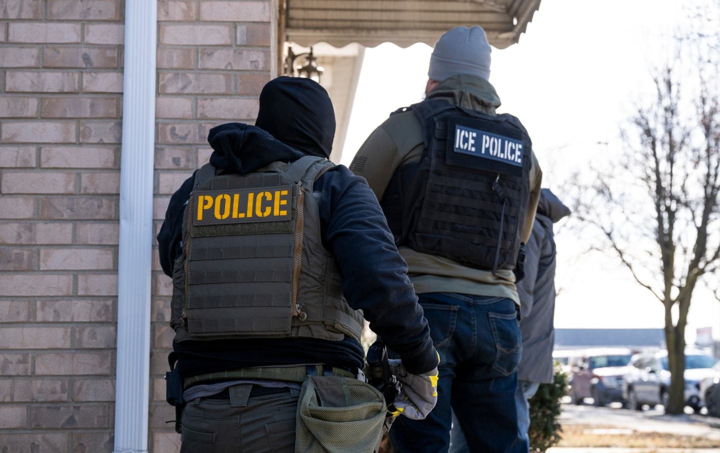 US Immigration and Customs Enforcement (ICE) agents knock on the door of a residence during a multi-agency targeted enforcement operation in Chicago, Illinois, on Sunday, January 26, 2025.