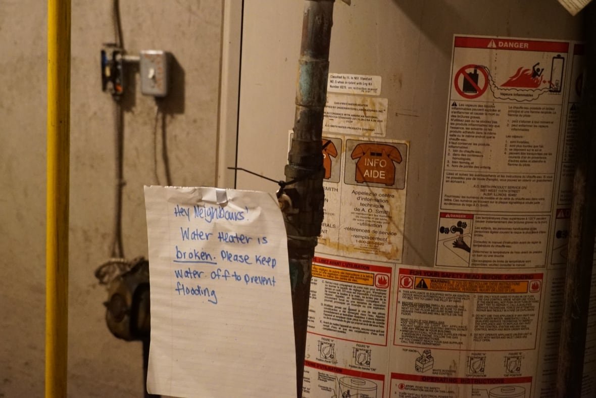 The water heater at West's other rental at 308 Egerton Street in London has a sign warning others not to use it since it's broken. Tenants are trying to get it fixed but are told they may have pay out of pocket, which is not affordable for most. 