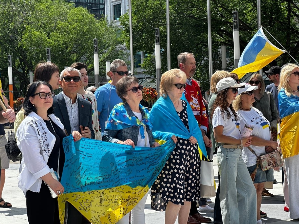 Protesters holding up Ukraine flags were present at Calgary City Hall on Saturday.