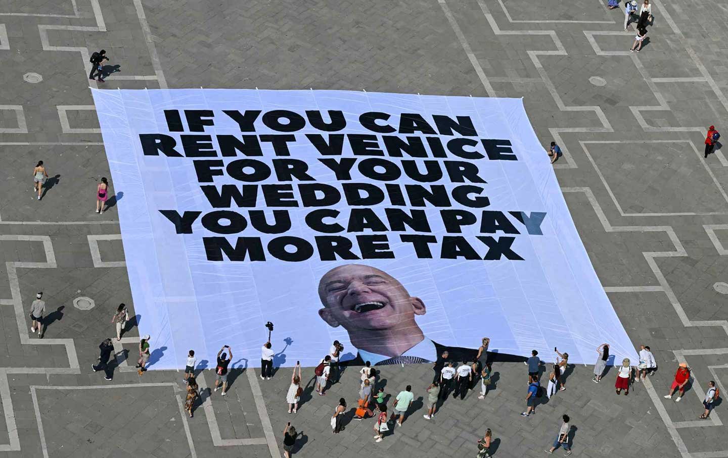 Greenpeace activists deploy a giant banner at St. Mark’s Square in Venice on June 23, 2025.