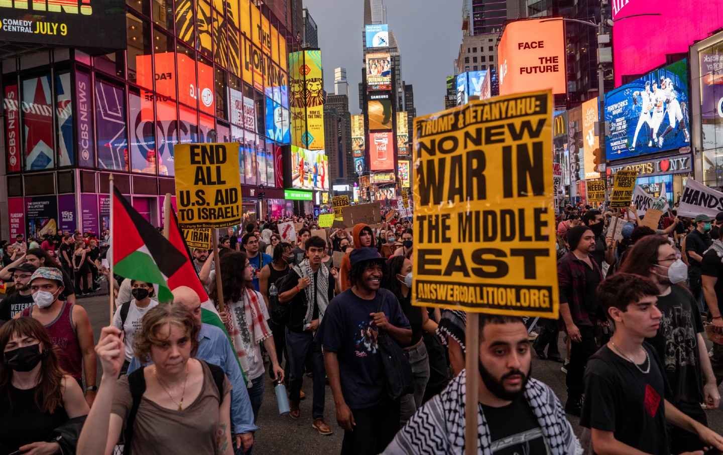 People march in Times Square during a rally calling for the Trump administration not to go to war with Iran, on June 18, 2025, in New York City.