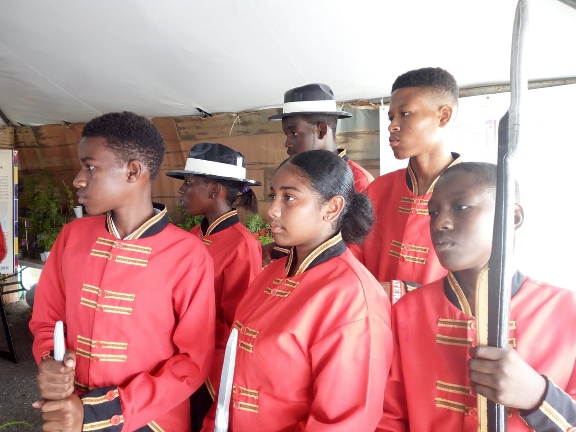 Children wear military costumes during a reenactment.