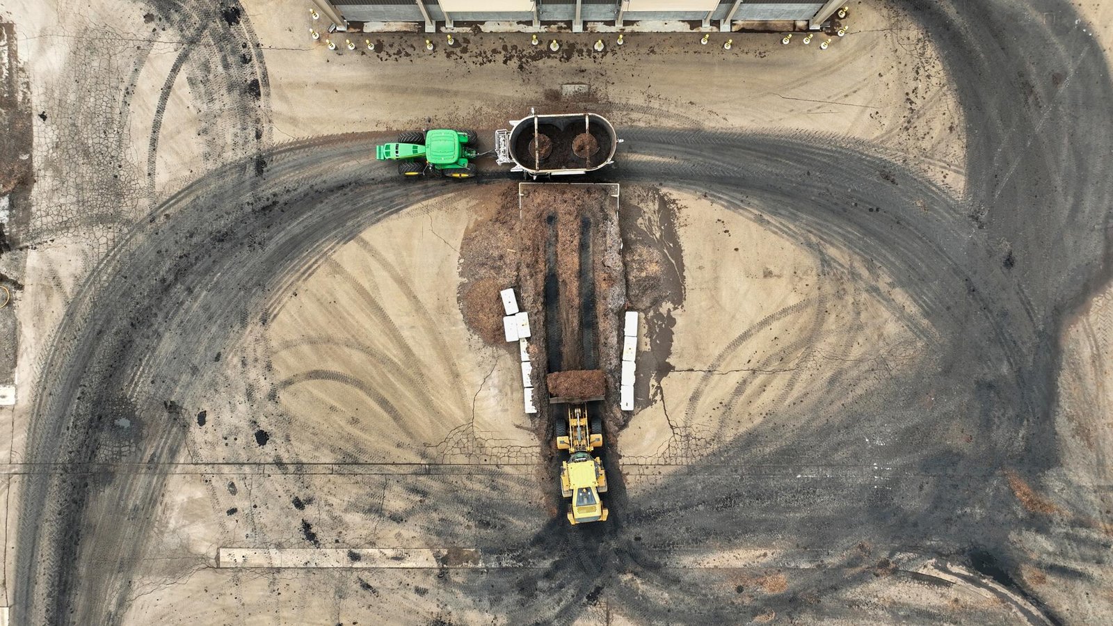 Material is delivered to a mixing truck where biosolids and amendments are combined then stored in climate controlled piles
