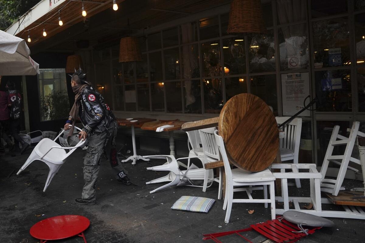 A demonstrator tosses a restaurant chair