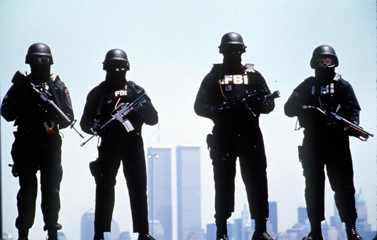 A masked FBI SWAT team poses for a photo.