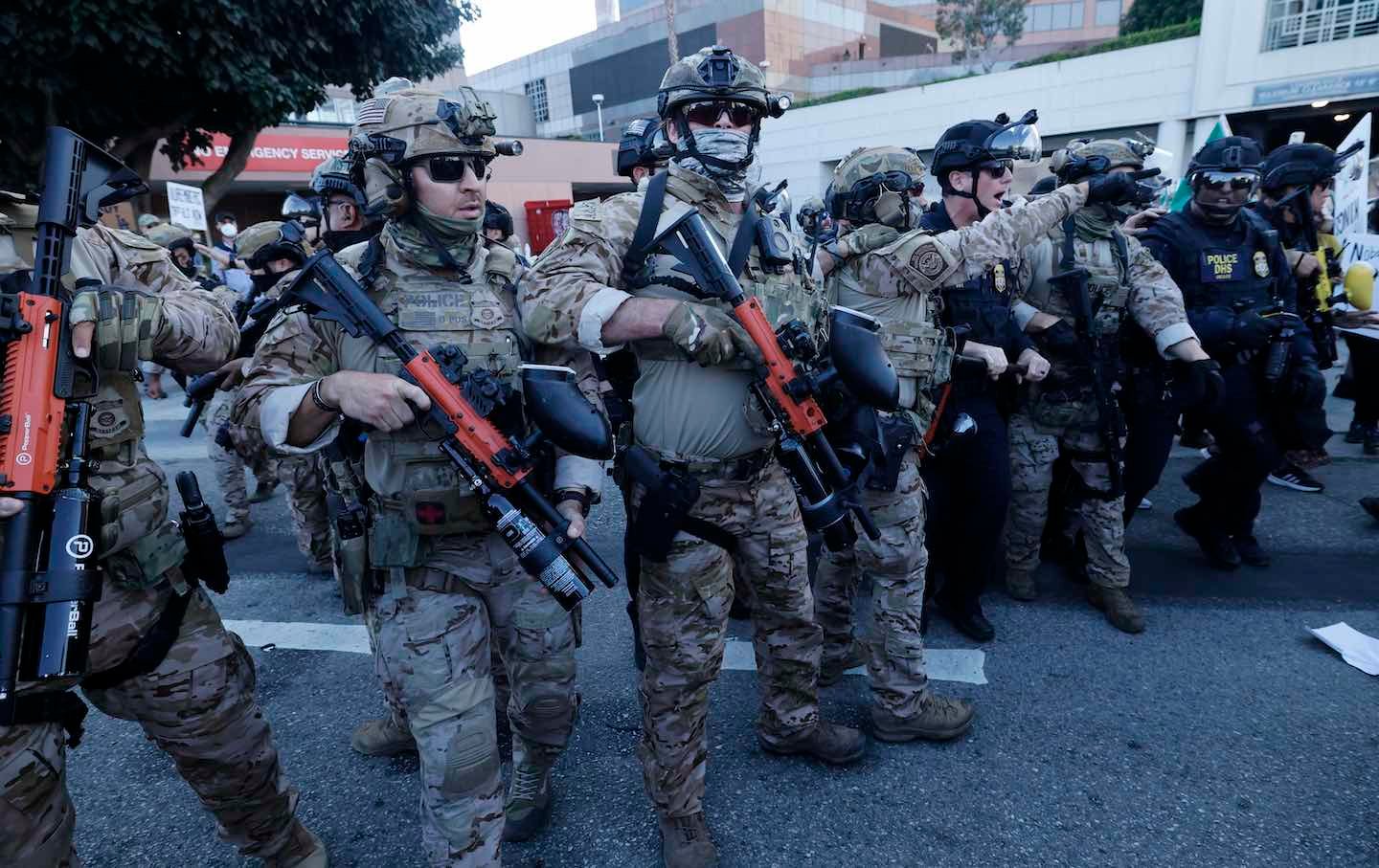 US Customs and Border Protection officers and DHS police push back protesters as they rally against the ongoing ICE raids taking place in the city, on July 4 in Los Angeles.
