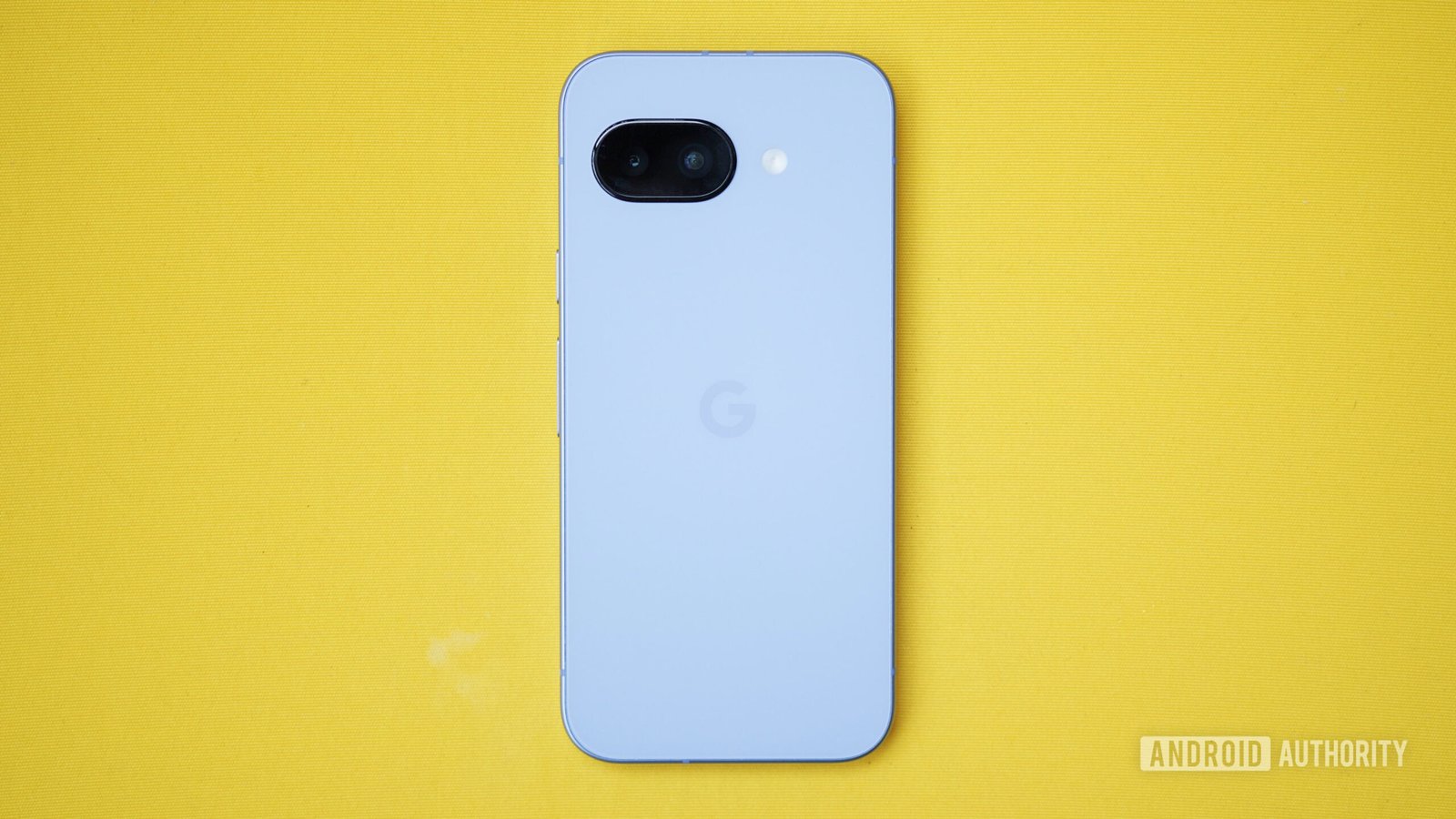 google pixel 9a back yellow background The Google Pixel 9a lying face-down on a yellow cushion.