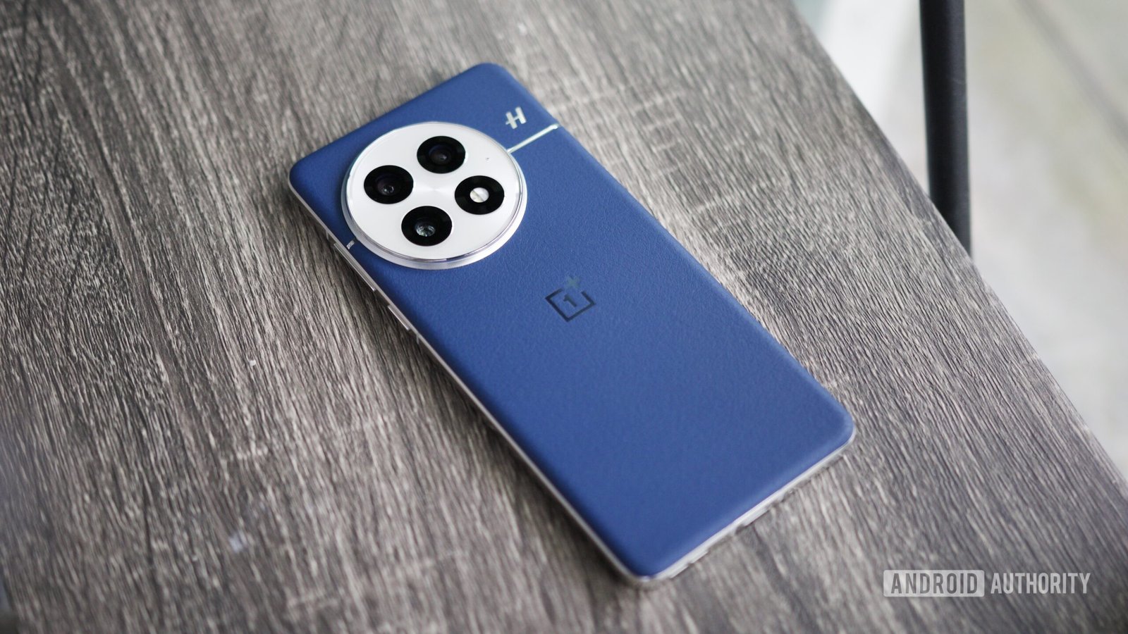 oneplus 13 back blue leather hero feature The blue leather OnePlus 13 lying on a shelf.